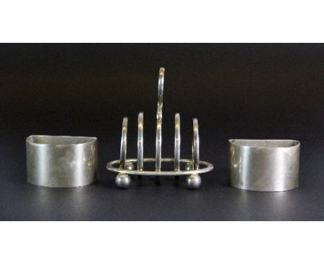 A small hallmarked toast rack and two hallmarked silver napkin rings, Walker and Hall