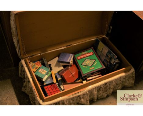 A dome topped trunk and contents of various games 