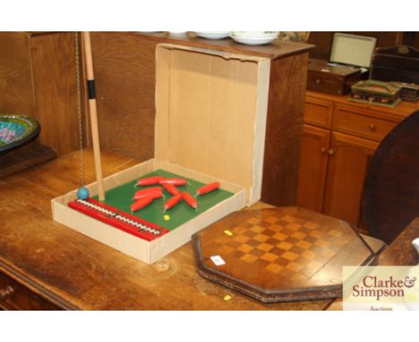 A Victorian inlaid games board and a tethered skittles games by Chad Valley