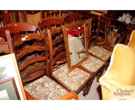 A set of four ladder back dining chairs