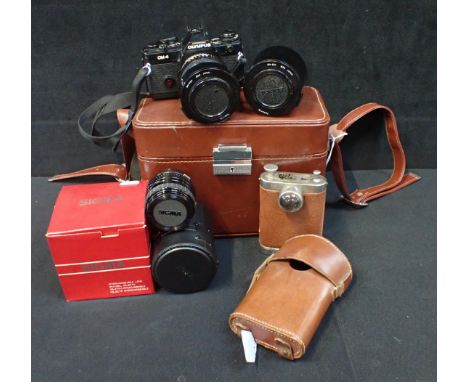 AN OLYMPUS OM-4 35MM SLR CAMERA with two Tonkina lenses and a Sigma 28mm lens, contained in brown leatherette case, and a lea