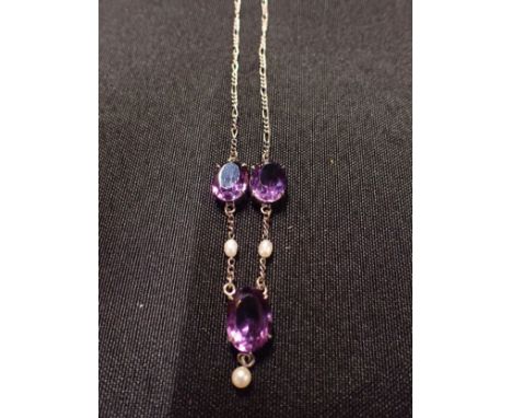 A SILVER AMETHSYT AND PEARL NECKLACE OF EDWARDIAN STYLE The figaro link chain set with three amethysts separated by rice pear