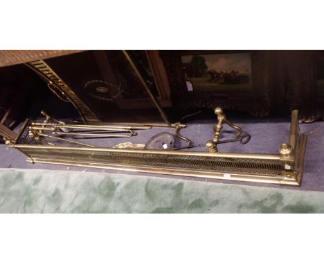 A SET OF BRASS FIRE TOOLS AND FIRE DOGS a similar brass fender, chestnut roaster and a (damaged) firescreen