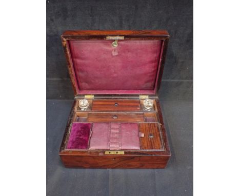 A VICTORIAN ROSEWOOD DRESSING BOX with fitted interior, and mother-of-pearl cartouche 30cm wide