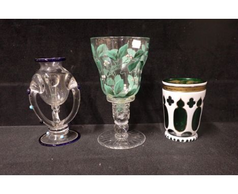 A BOHEMIAN OVERLAY GLASS BEAKER, a repaired green and white overpainted glass, inserted into a Webb Corbett candlestick and a