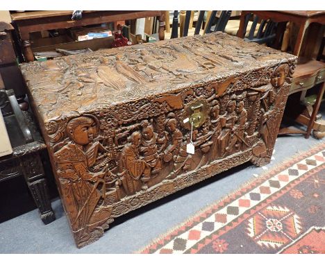 A CHINESE CAMPHORWOOD TRUNK, PROFUSELY CARVED 105cm wide