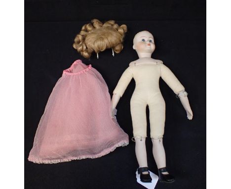 A SIMON &amp; HALBIG BISQUE HEAD DOLL No. 117, with bisque shoulders, legs and arms 40cm high