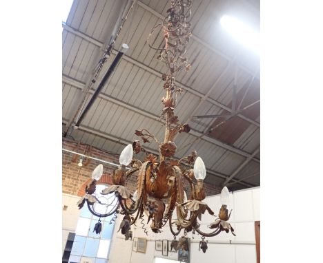 A GILT TOLEWARE SIX-BRANCH CHANDELIER worked with flowers and scrolling leaves, with leafy pendants, and matching sectional s