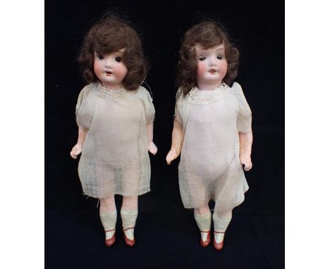 TWO EARLY 20TH CENTURY GERMAN BISQUE-HEAD DOLLS with composition bodies and painted limbs, 1920s hairstyles and muslin dresse