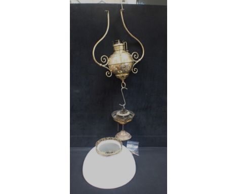 A LATE 19TH CENTURY AMERICAN BRASS PENDANT OIL LAMP by Miller, the bulbous body with white metal leaf motif and with white gl