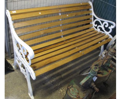 Stained garden bench with cast iron scrolled and pierced arms and supports.
