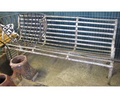 Large wrought iron garden bench with open and scroll arms.