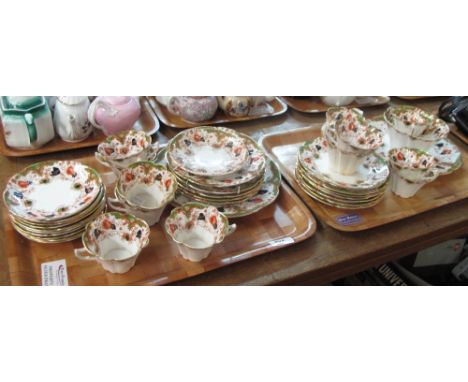 Two trays of Duchess china tea ware items on a white ground with gilt floral and foliate decoration comprising tea cups, sauc