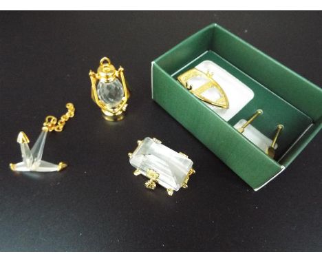 Swarovski Crystal Memories - four crystal miniatures comprising an Anchor, a Treasure Chest, a Marine Lamp and a Rowing Boat 