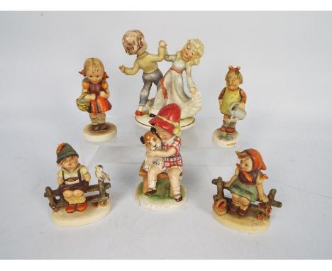 Goebel - A Kathe Kruse designed figure depicting a girl and a dog (red hat), a figural group of a boy and a girl dancing and 