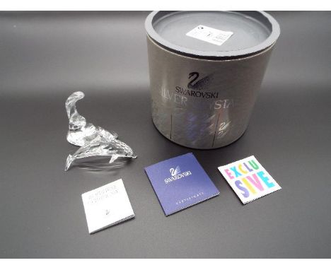 Swarovski Crystal - a Dolphin with Wave stand, boxed with internal packaging, be aware that although the item appears to be i