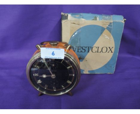 An atomic style orange bodied alarm clock by Westclox with box