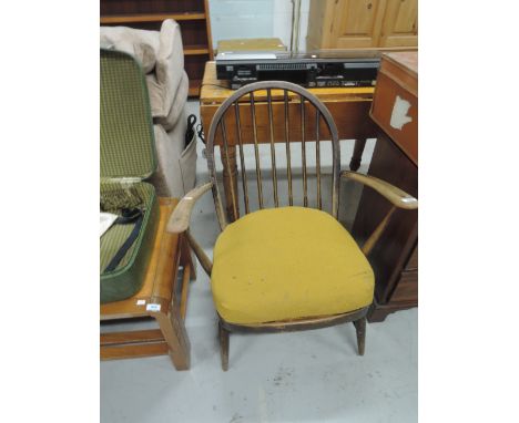 A vintage spindle back armchair, in the Ercol style, part stripped