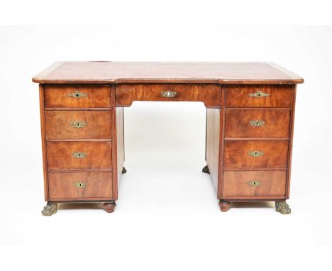 A Napoleon III walnut veneered twin pedestal desk, with brass armorials bearing the initial N and surmounted by a spread-eagl