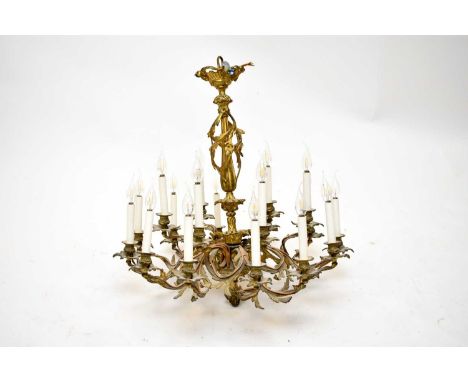 A Continental gilt brass rococo revival chandelierHaving eighteen foliate scroll branches issuing from a central knopped balu
