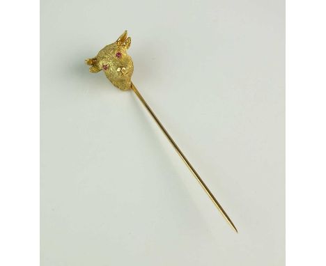 A yellow metal Bull's head stick pin, the naturalistically modelled head with two cabochon ruby set eyes, indistinctly engrav