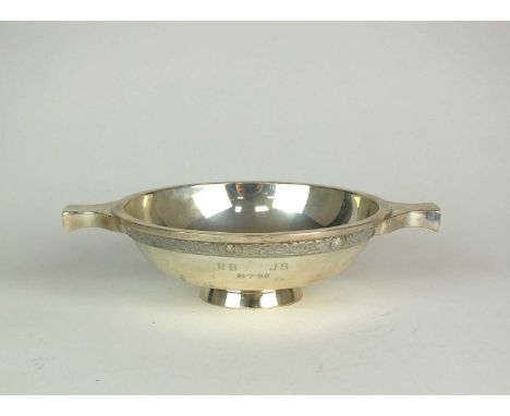 A silver quaich, Hamilton &amp; Inches, Edinburgh 1998, of typical form with Celtic design rim and raised on collet foot, 15c