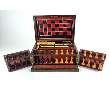 A Victorian walnut and rosewood games compendiumThe hinged lid and opening front revealing a fitted interior with fold-out le