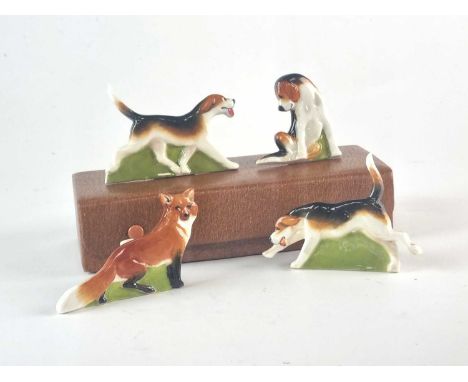 A Royal Worcester set of hunting fox and hound menu holders, modelled by Doris Lindner, circa 1932.models, 2953, 2954, 2955, 