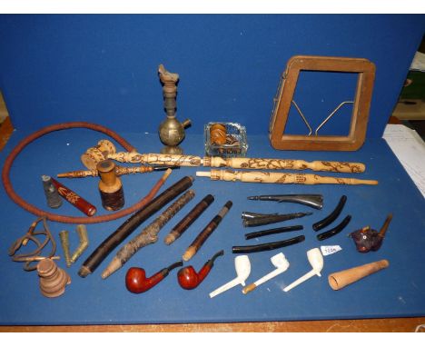 A large tray containing parts of a Hookah pipe, several "peace" pipes, one is sectional at over 1m in length, a Senior Servic
