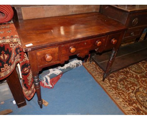 A circa 1900 cross banded topped Mahogany Lowboy/Writing Table having three frieze drawers with wooden knobs and light and da