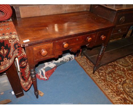 A circa 1900 cross banded topped Mahogany Lowboy/Writing Table having three frieze drawers with wooden knobs and light and da