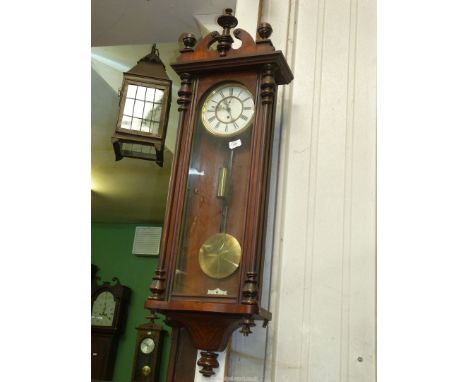 A Walnut/Mahogany cased Vienna type Wall Clock having a single train weight driven movement, the face with Roman numerals, 48