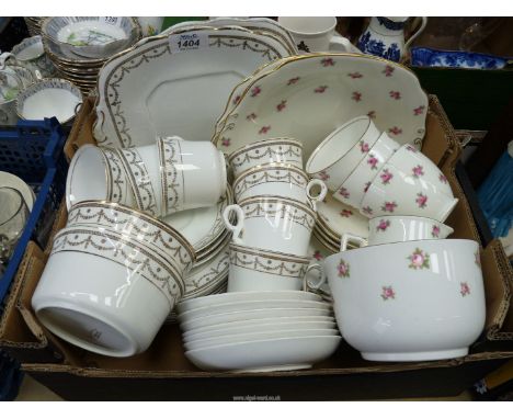 A Cauldon part tea set, white with pink roses including three cups and five saucers, eight tea plates, two bread and butter p