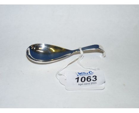 An early 19th century pear shaped hook handled Caddy Spoon, stamped London 1803, maker William Eley and William Fearn.
