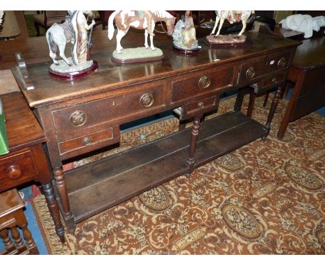 An early 19th c. Oak Potboard Welsh Dresser Base having three frieze drawers and three spice/trinket drawers with bronzed dro