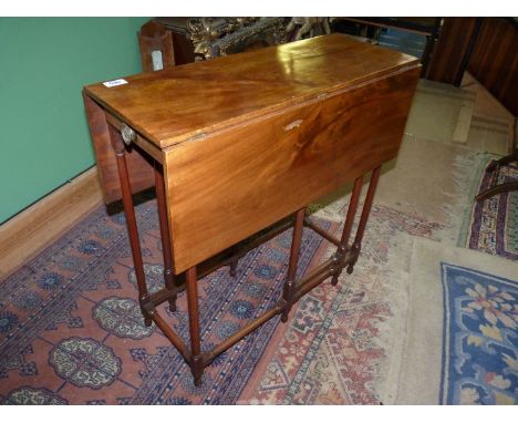 A 19th Century Mahogany Sutherland drop-leaf gate-leg table standing on spindle legs and stretchers and having an unusually l