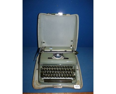 A green Olympia portable typewriter in case.