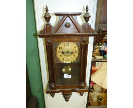 A compact darkwood cased Wall Clock, having a two-train spring driven movement, the face having Arabic numerals, 26 1/2'' hig
