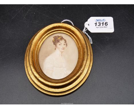 A finely painted miniature head and shoulders Portrait of an attractive young woman, late 18th/early 19th century in a later 