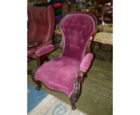 A Mahogany/Walnut framed Victorian button-backed open armed Armchair having art nouveau style carving to the arms extending d