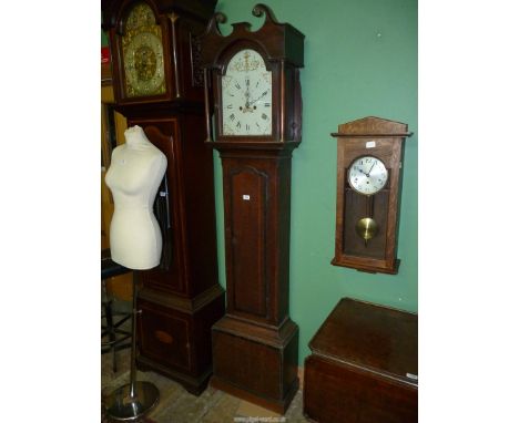 A cross-banded Oak cased Longcase Clock having a painted face with Roman hour numerals and Arabic minutes with an inset secon