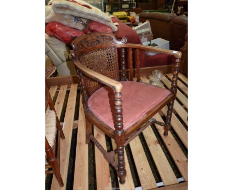 An unusual mixed woods open armed Elbow Chair having a scroll decorated carved and fretworked top rail, a caned panel to the 