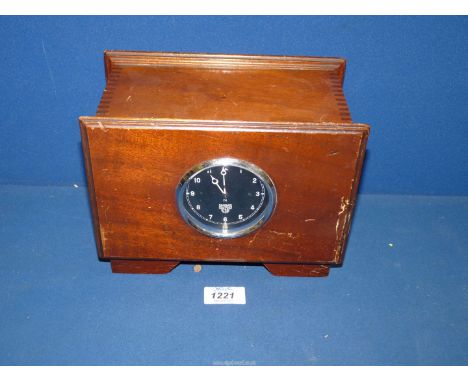 A Smiths motorcar Dash-board Clock having knurled under-dash winding and setting knob , the 3" diameter black face with Arabi