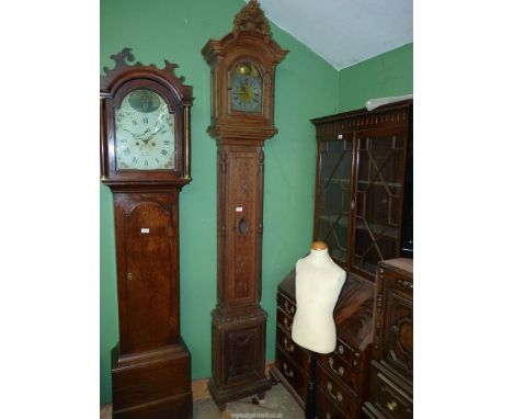 An unusually slender Oak cased long-case Clock, the case decorated in relief with bows and swags, a torch and a quiver of arr