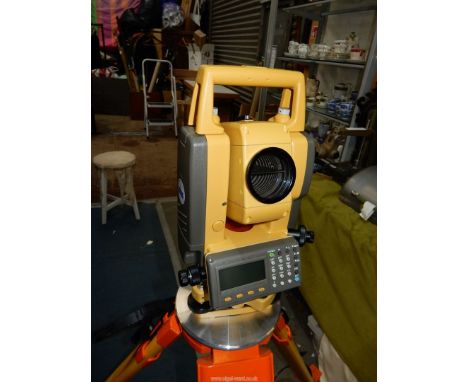 A hgand operative cased Tapcon Green Label GTS 105N Electronic Total Station iwht power nut, battery pack, field cover and in