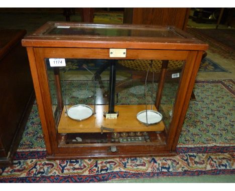 A Scientific beam balance Scales with weights in glazed display case by F.E. Becker &amp; Co.