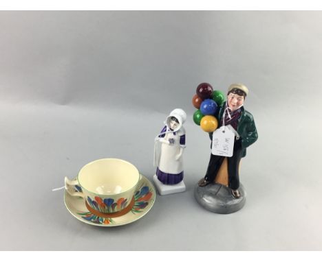 CLARICE CLIFF FOR WILKINSON TEA CUP AND SAUCER, decorated with the Crocus pattern, along with two Royal Doulton figures of 'B