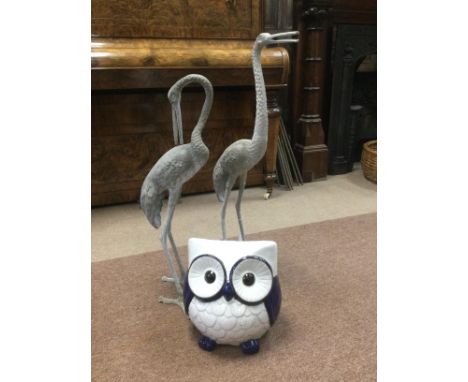 TWO METAL HERON GARDEN FIGURES, the tallest 81cm high, along with a modern ceramic figure of an owl (3)