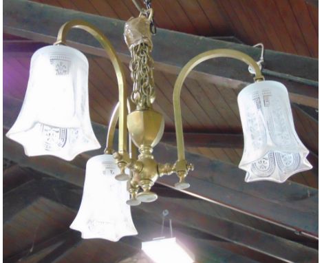 A good quality Edwardian cast brass three branch ceiling light with faceted lobed glass shades