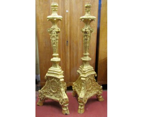A pair of substantial cast torcheres or lamp standards on tricorn bases, with hoof supports and overall decorated finish, 180